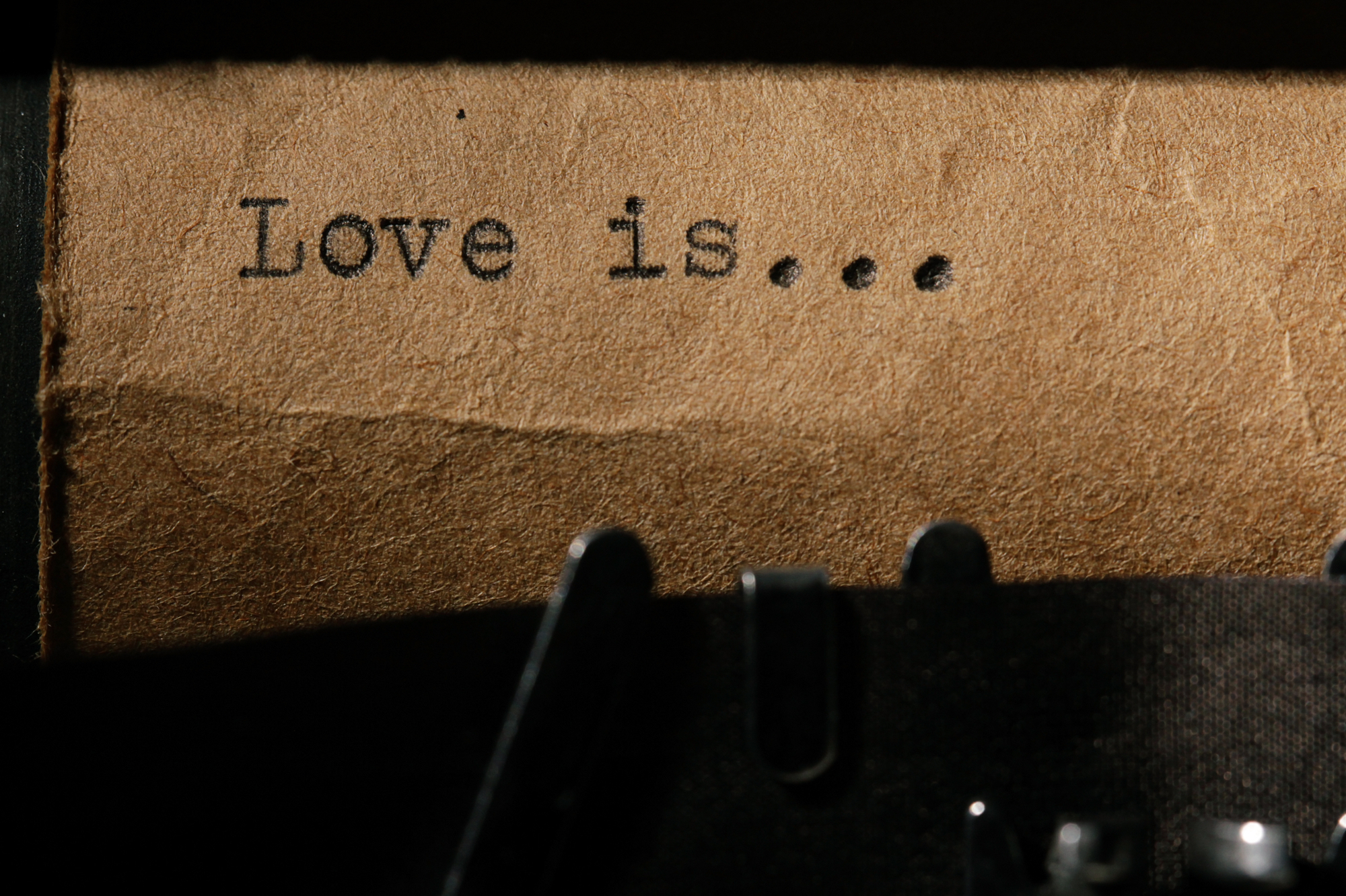 love is, the inscription on a typewriter